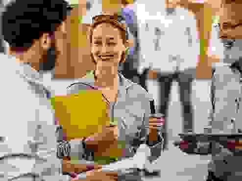 A women holding a clipboard smiling